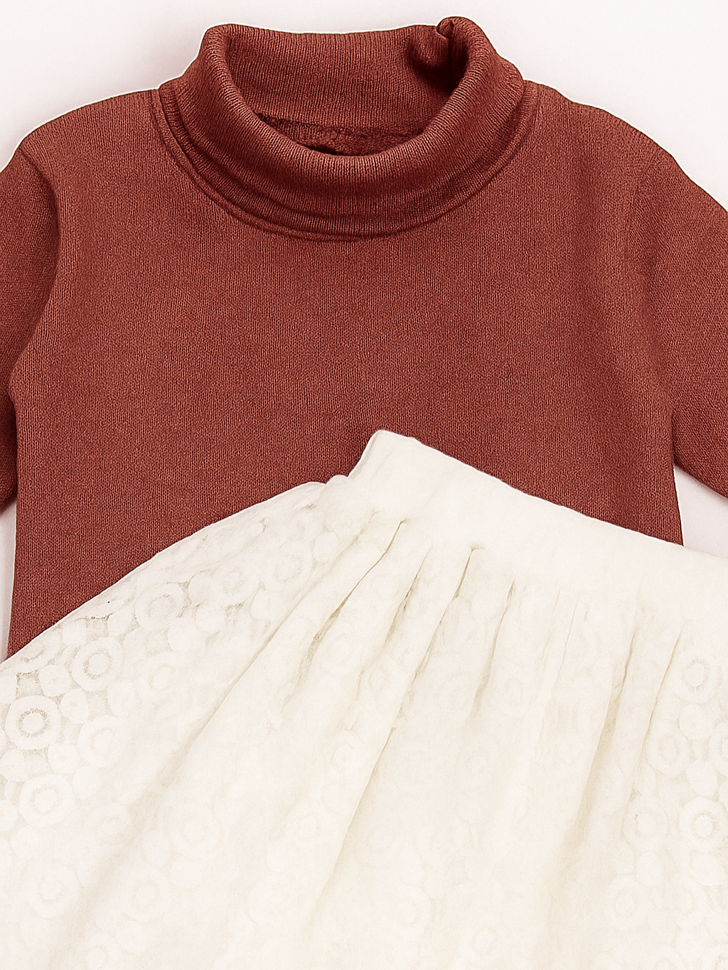 turtleneck top and white pleated skirt