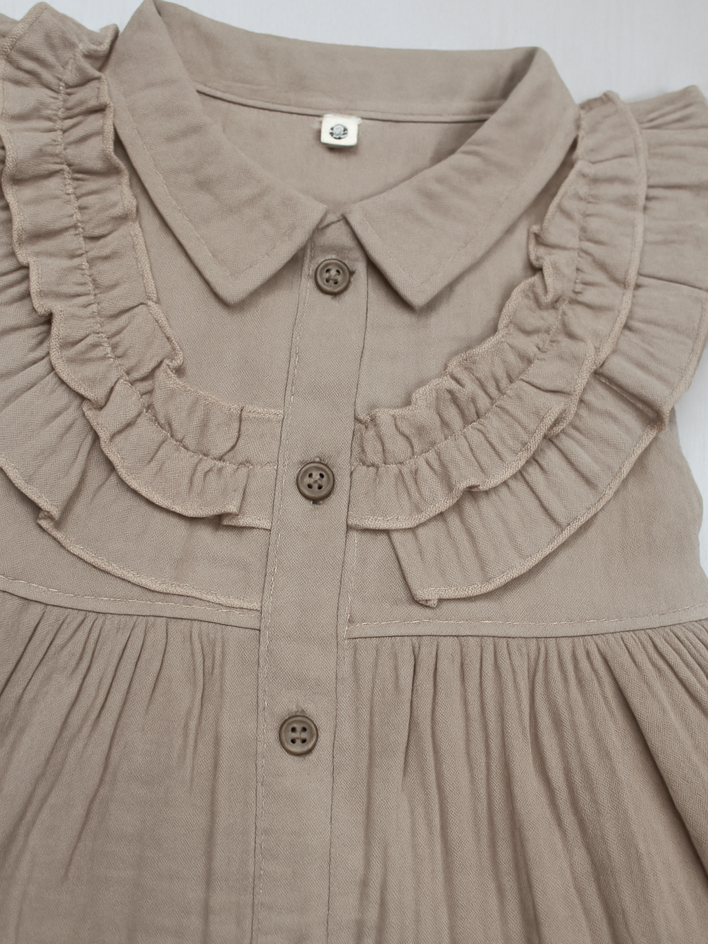 sleeveless beige ruffle dress